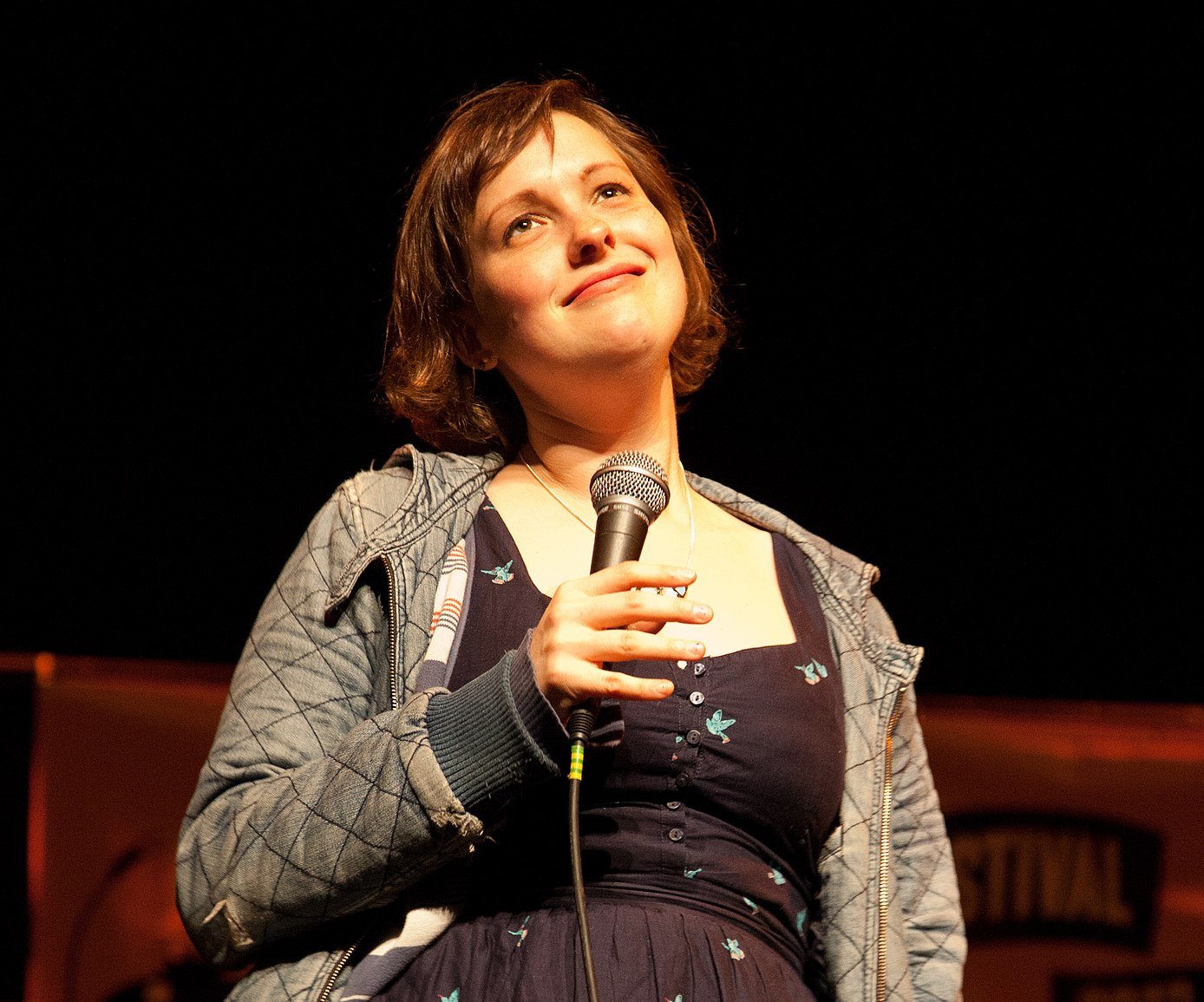 Portrait Photo of the comedian Josie Long performing on a stage