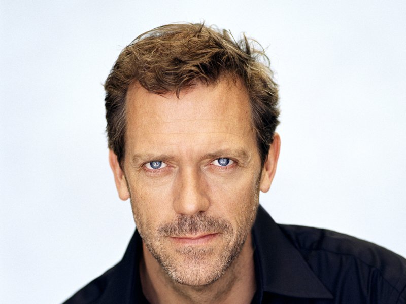 Portrait Photo of the Actor Hugh Laurie in a dark shirt facing the camera