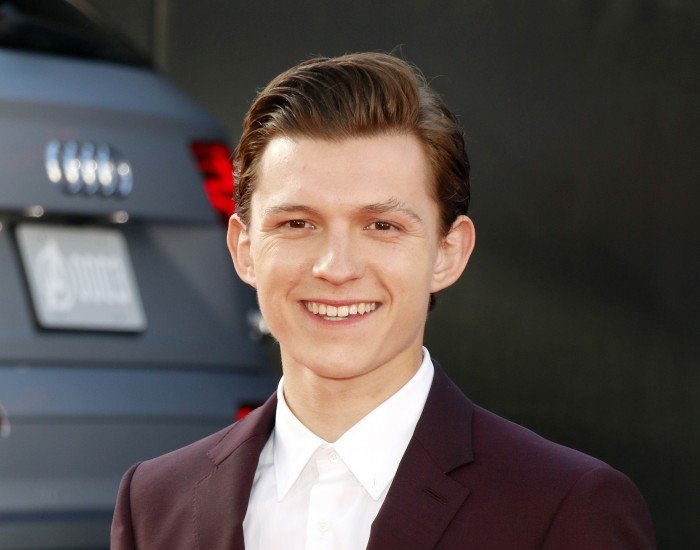 Portrait Photo of the Actor Tom Holland in a brown suit