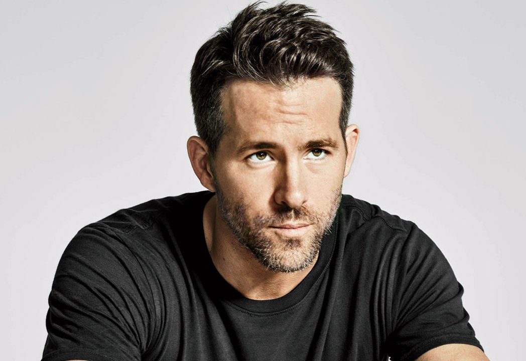 Portrait Photo of the Actor Ryan Reynolds in a black t-shirt, facing the camera