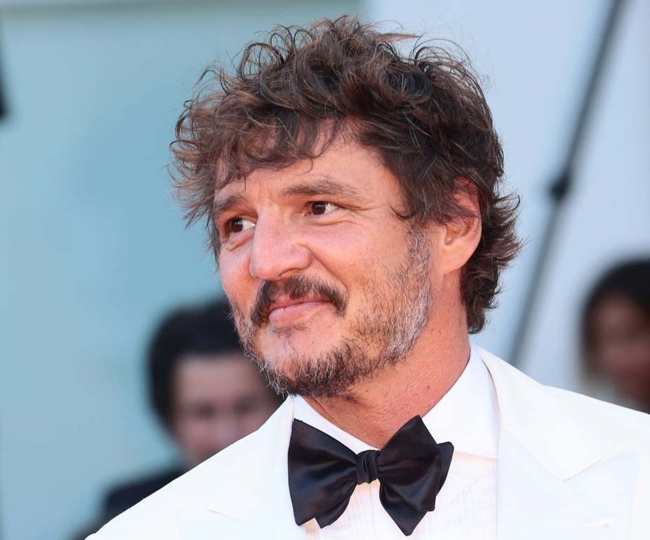 Portrait Photo of the Actor Pedro Pascal in a white suit