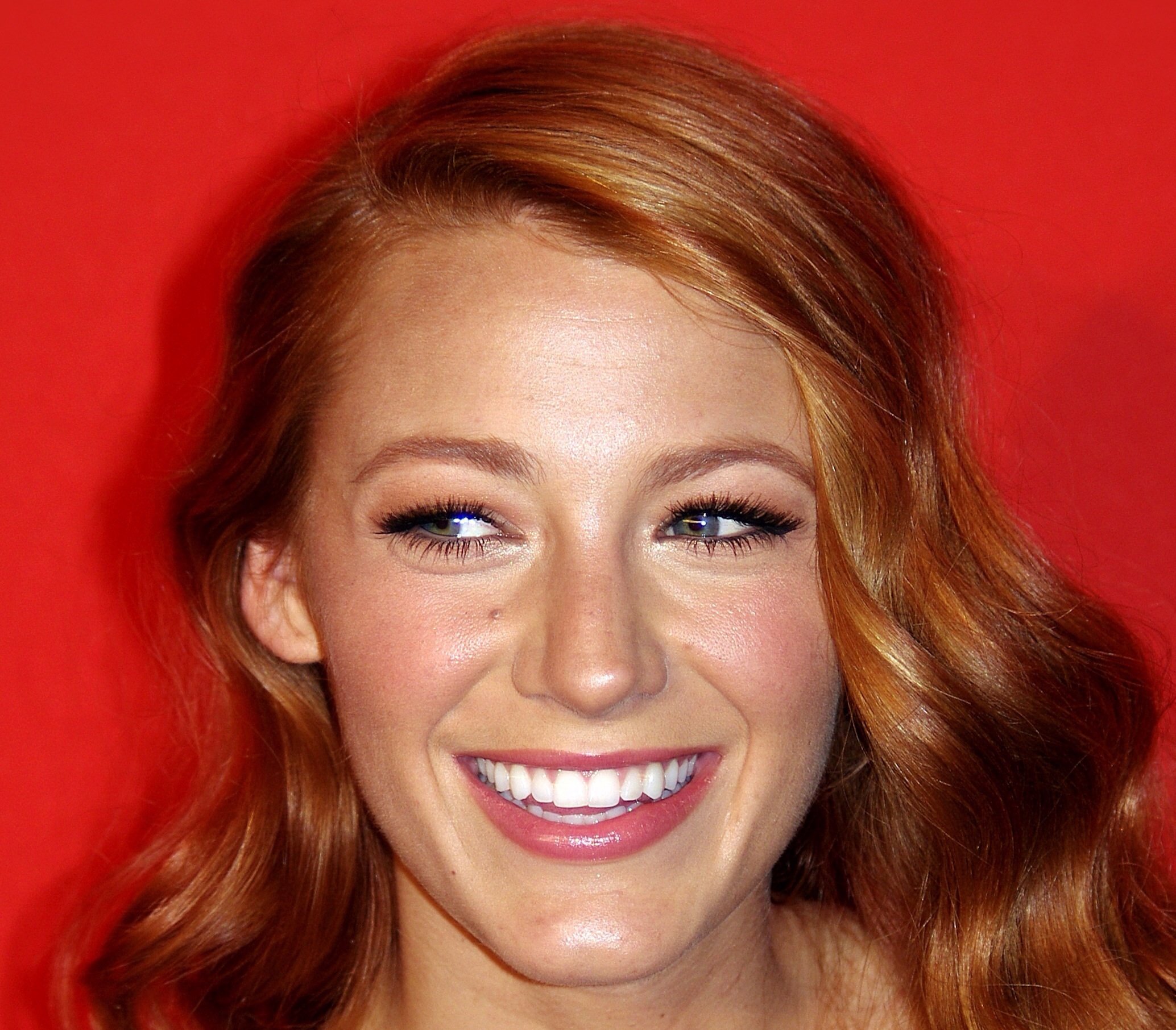 Portrait Photo of Blake Lively smiling, facing the camera and looking to the left