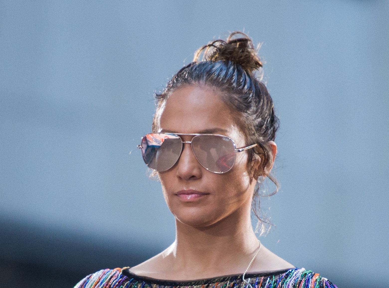 Jennifer Lopez with sun glasses looking at side.