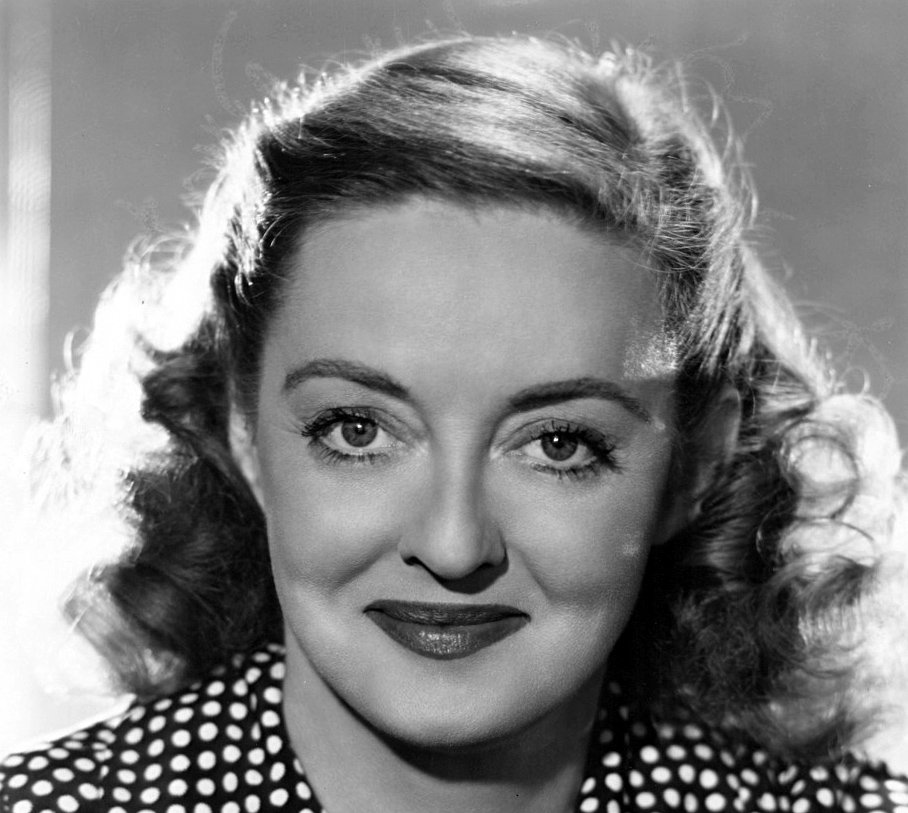 Grayscale Portrait Photo of Bette Davis in a black and white dress