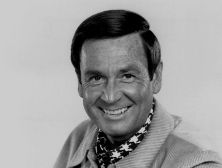 Grayscale Portrait Photo of Bob Barker, smiling and facing the camera.
