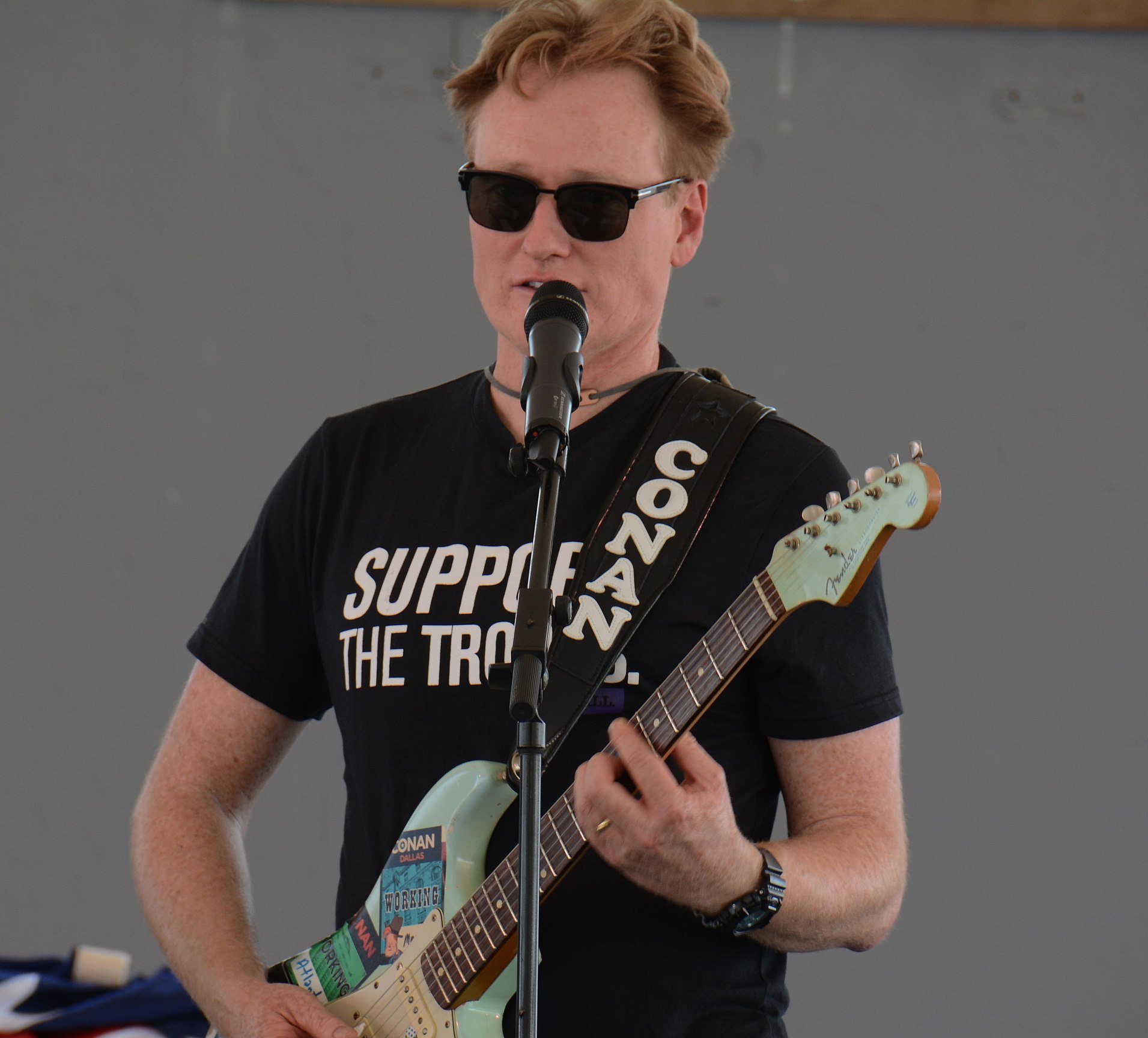 Late night talk show host and comedian, Conan O’Brien, plays his guitar
