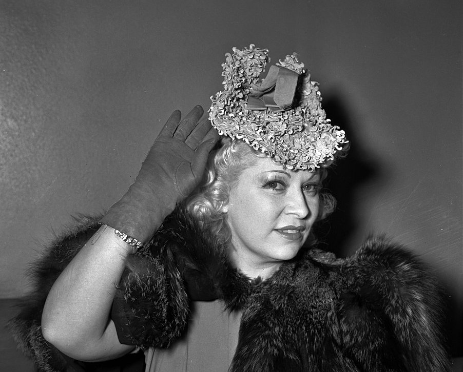 Mae West sitting in court during questioning about profits earned from her role in the movie She Done Him Wrong