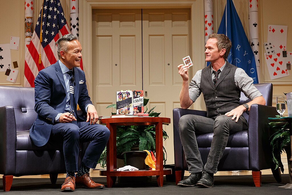 Neil Patrick Harris attempts a card trick with Library Chief Communications Officer Roswell Encina
