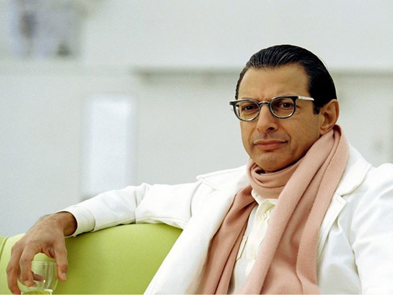 Jeff Goldblum in white suit is looking at side,