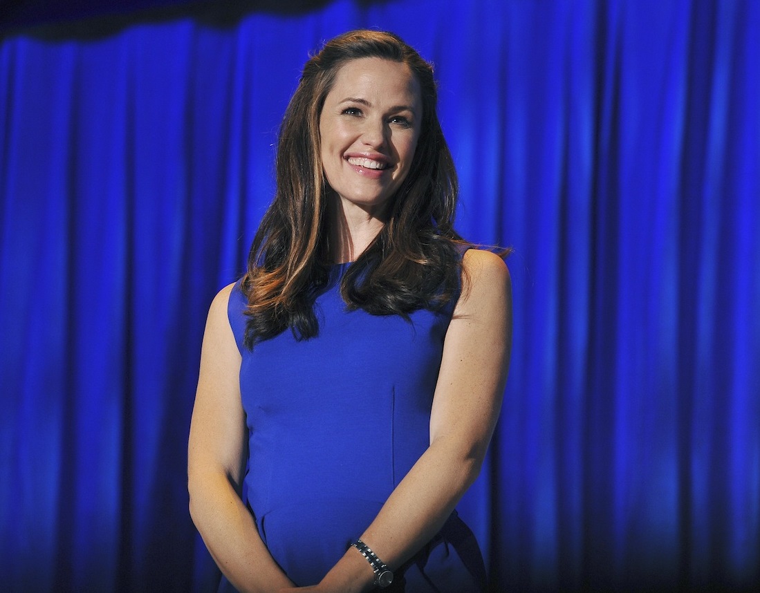 Jennifer Garner in blue dress is smiling.