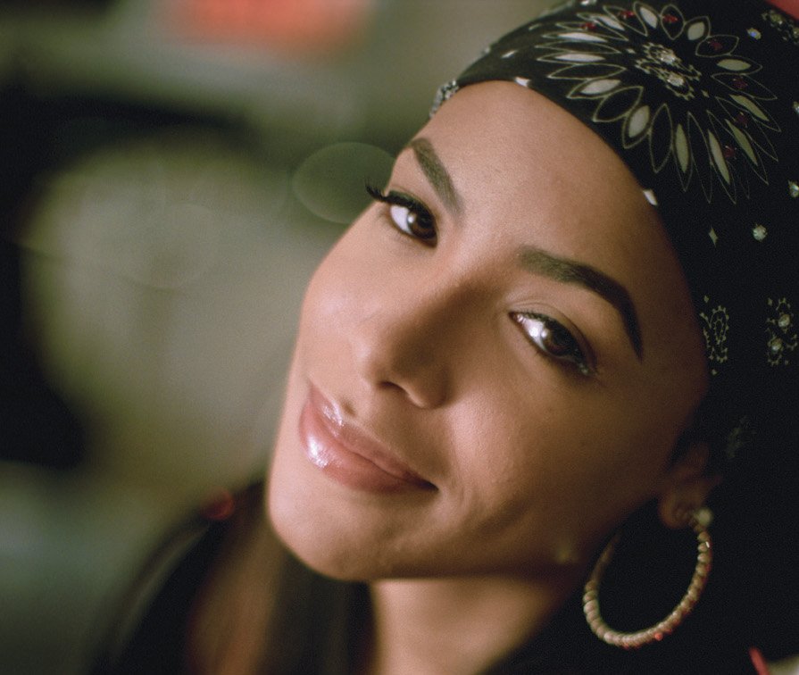 Portrait Photo of Aaliyah with a big ear ring, smiling, facing the camera