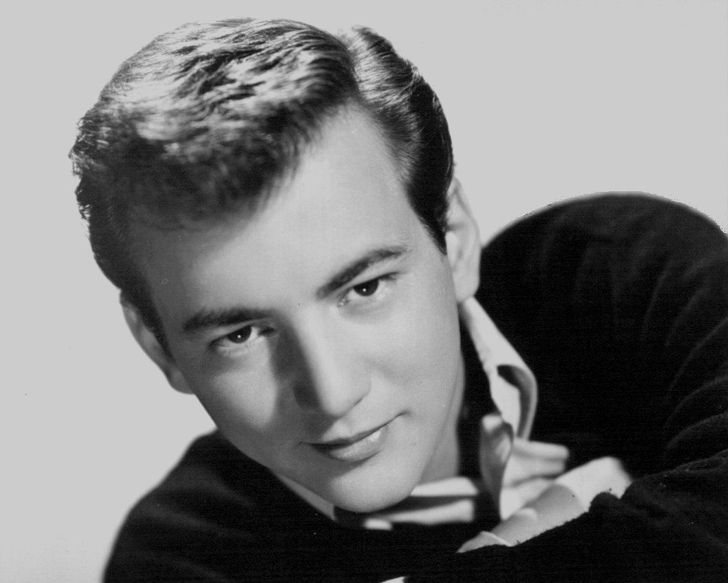 Grayscale Portrait Photo of Bobby Darin in dark outfit, facing the camera