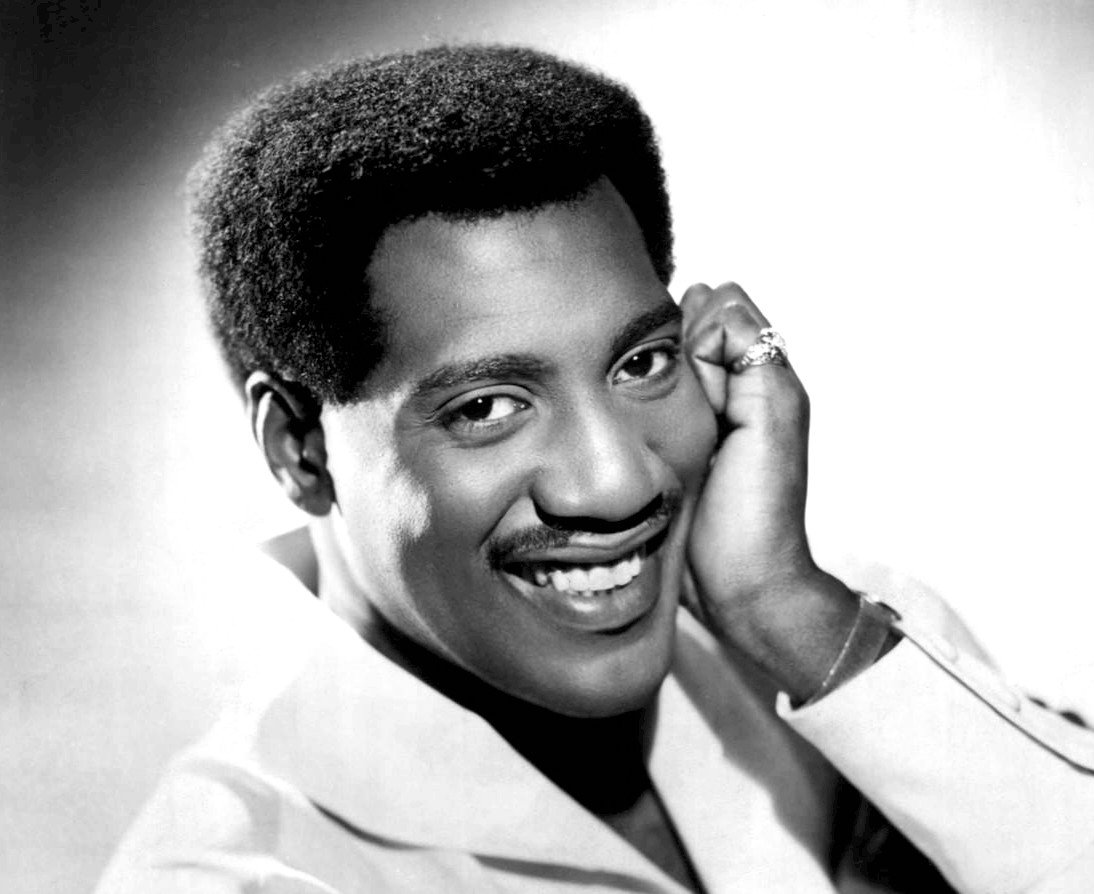 Grayscale Portrait Photo of singer Otis Redding in a white suit