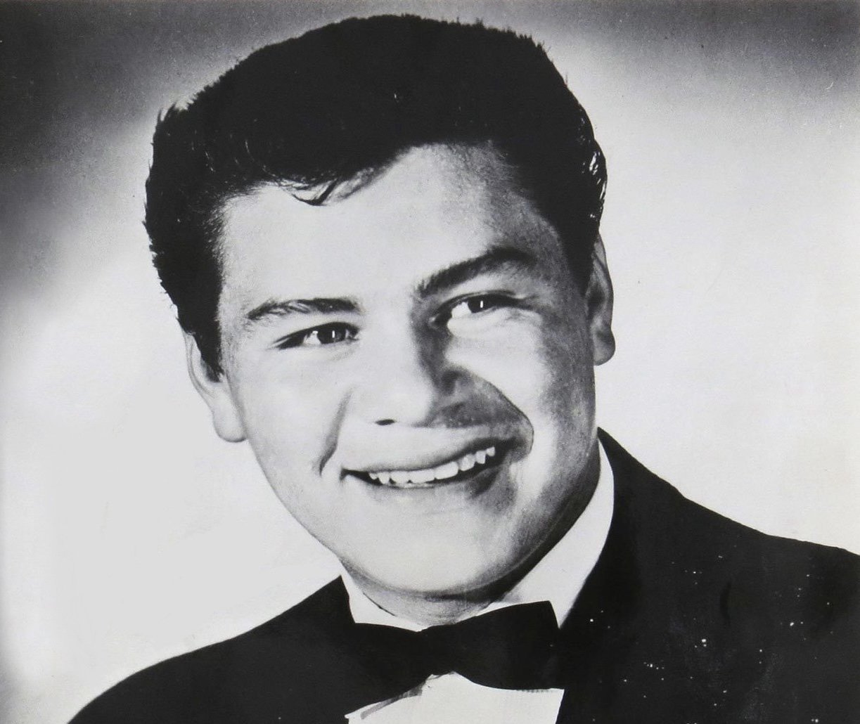 Grayscale Portrait Photo Ritchie Valens in a press photo dated to 1959