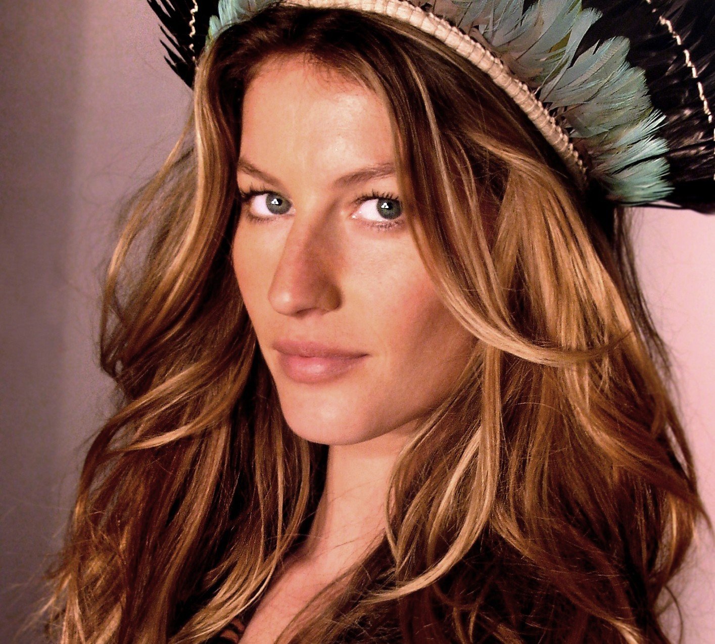 Portrait Photo of Gisele in a dark dress and hat facing the camera