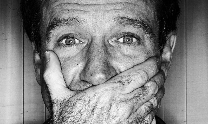 Grayscale Portrait Photo of American actor and comedian Robin Williams