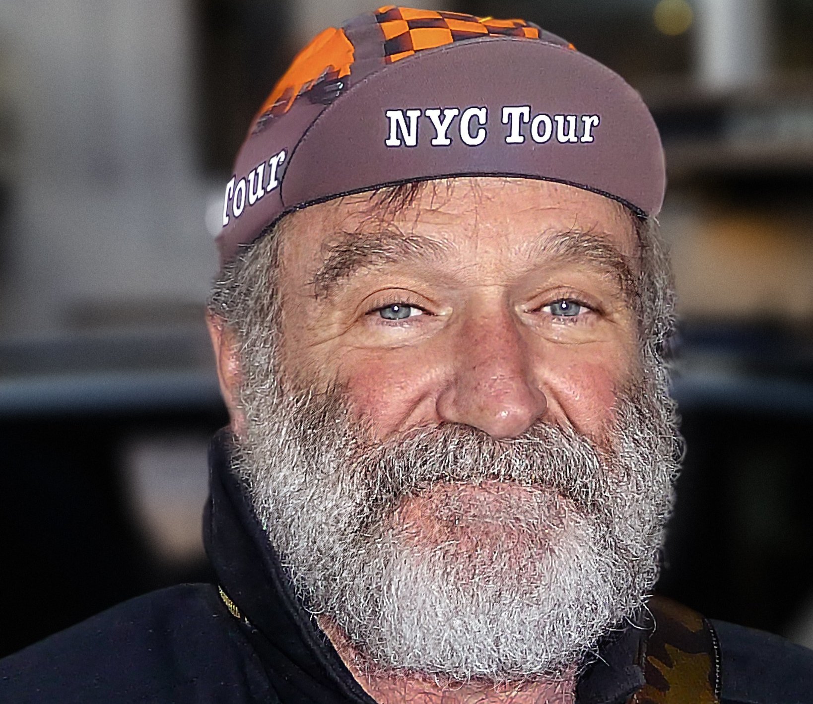 Portrait Photo of American actor and comedian Robin Williams wearing a hat