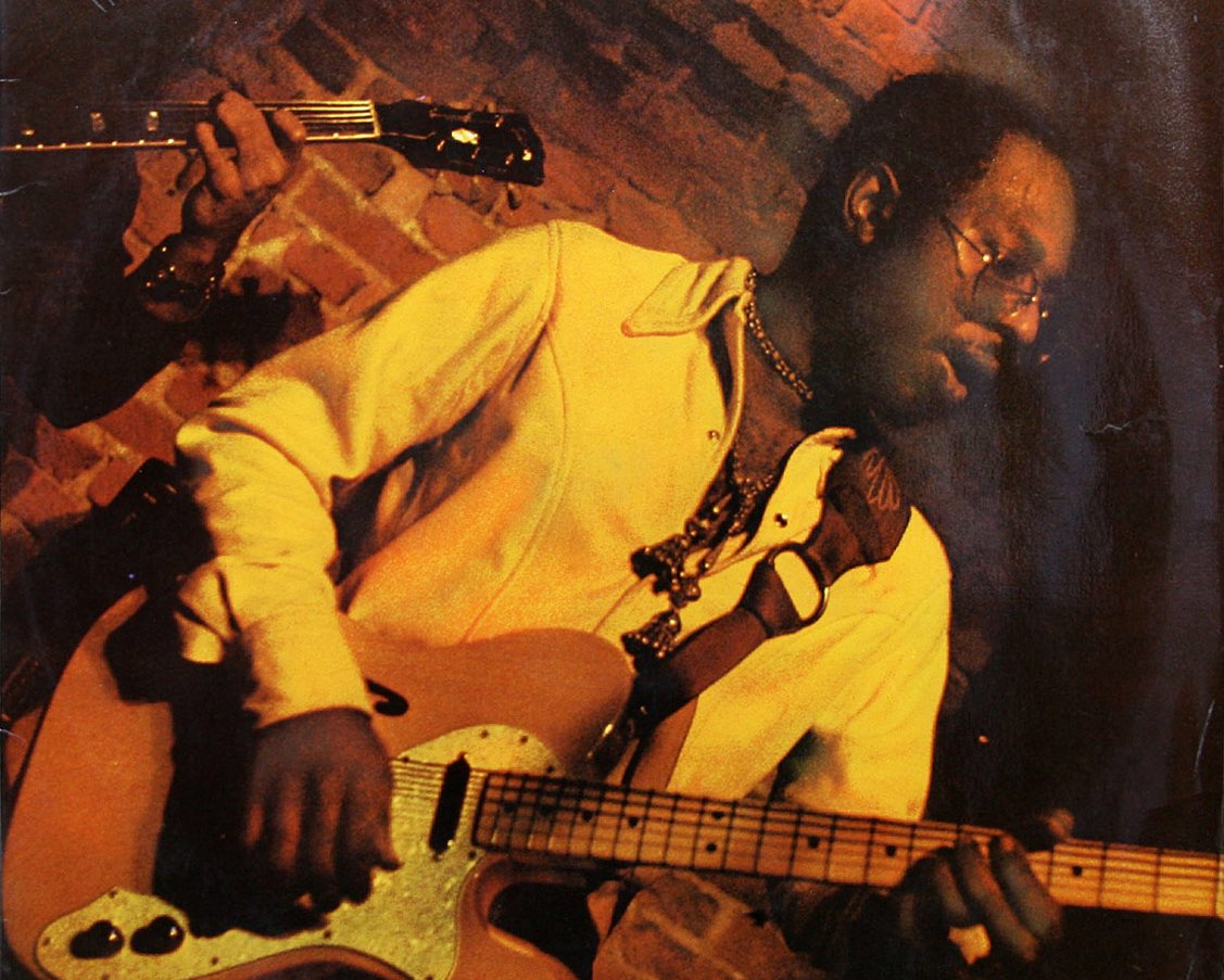 Portrait Photo of Curtis Mayfield performing with his guitar