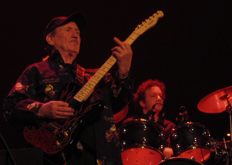 Portrait Photo of James Burton performing on stage with his guitar