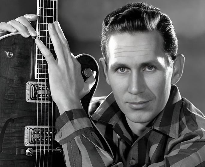 Grayscale Portrait Photo of Chet Atkins with his signature guitar