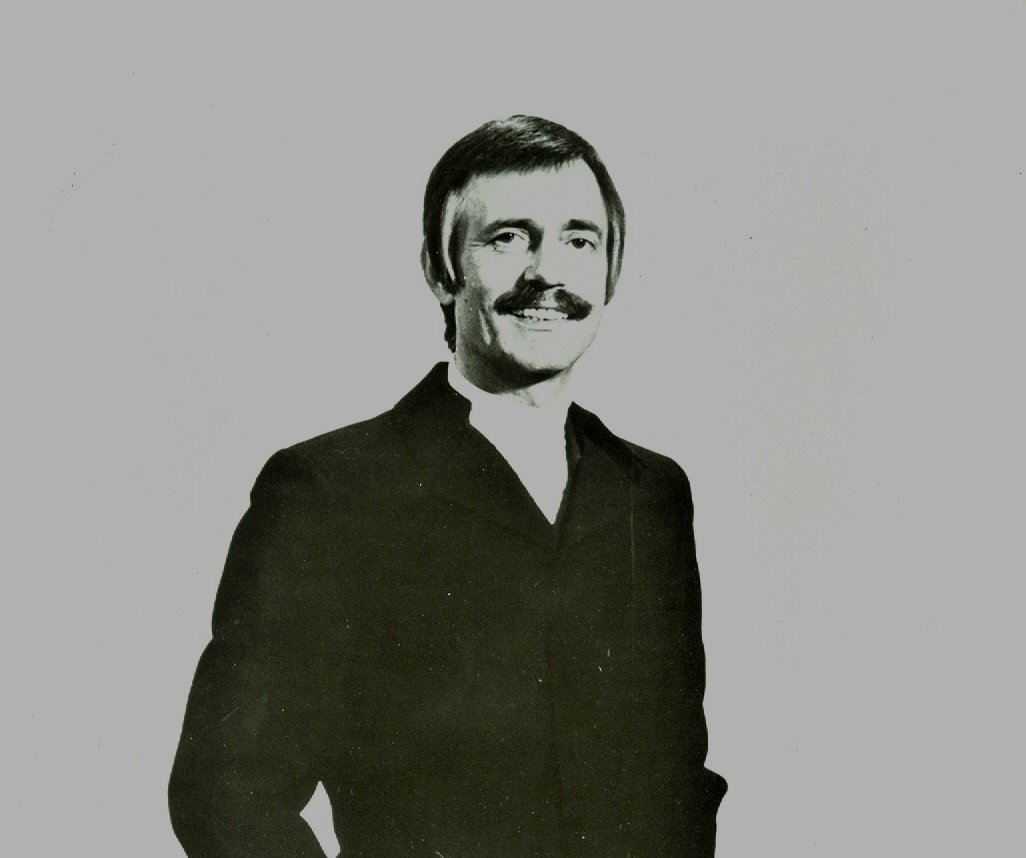 Grayscale Portrait Photo of Paul Mauriat a French orchestra leader in a dark suit