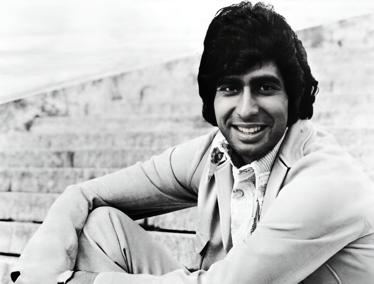 Grayscale Portrait Photo of the singer Andy Kim facing the camera and smiling