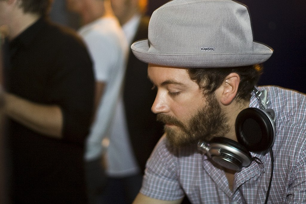 Portrait Photo of Danny Masterson in a gray shirt and gray hat