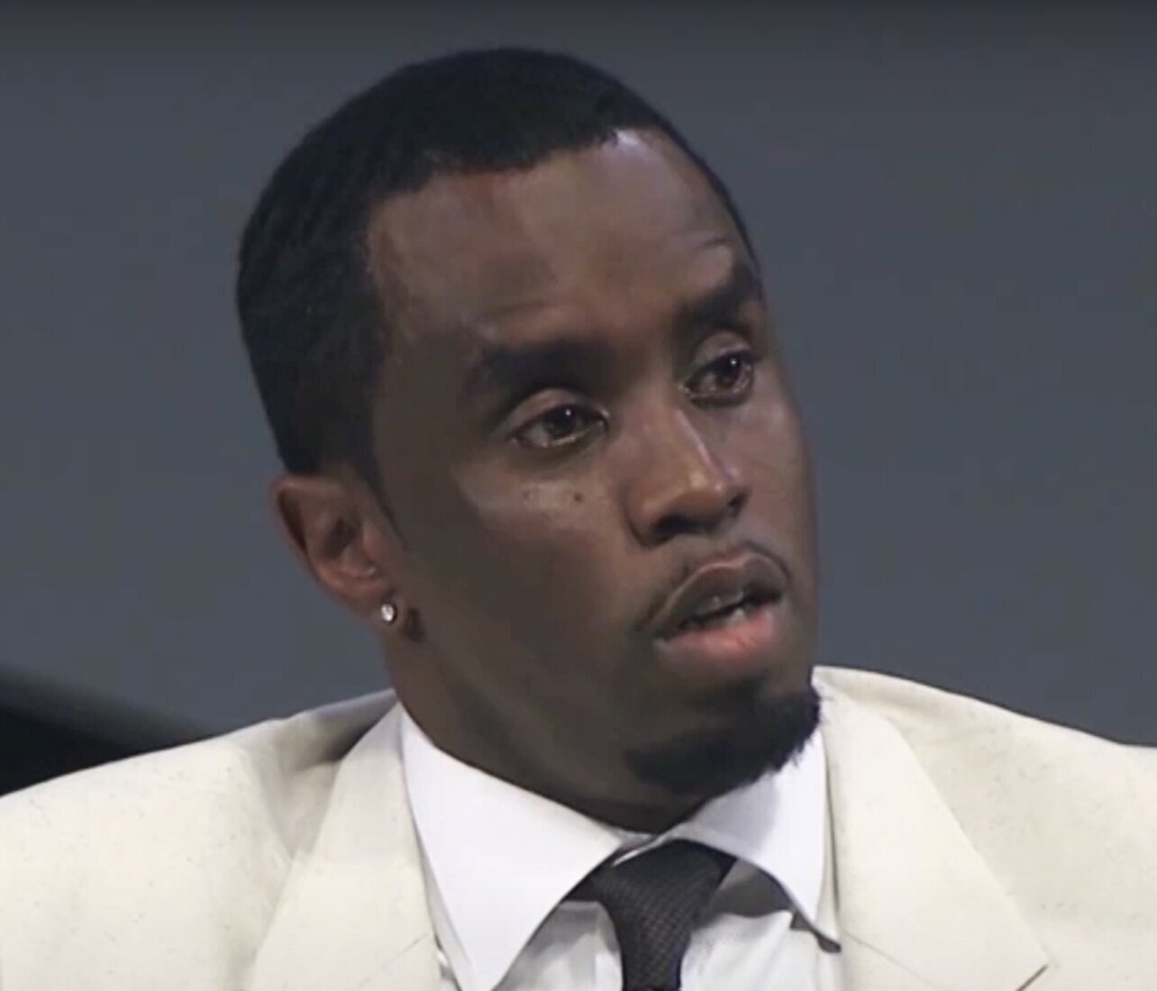 Portrait Photo of Sean Combs aka Sean P. Diddy in a white suit