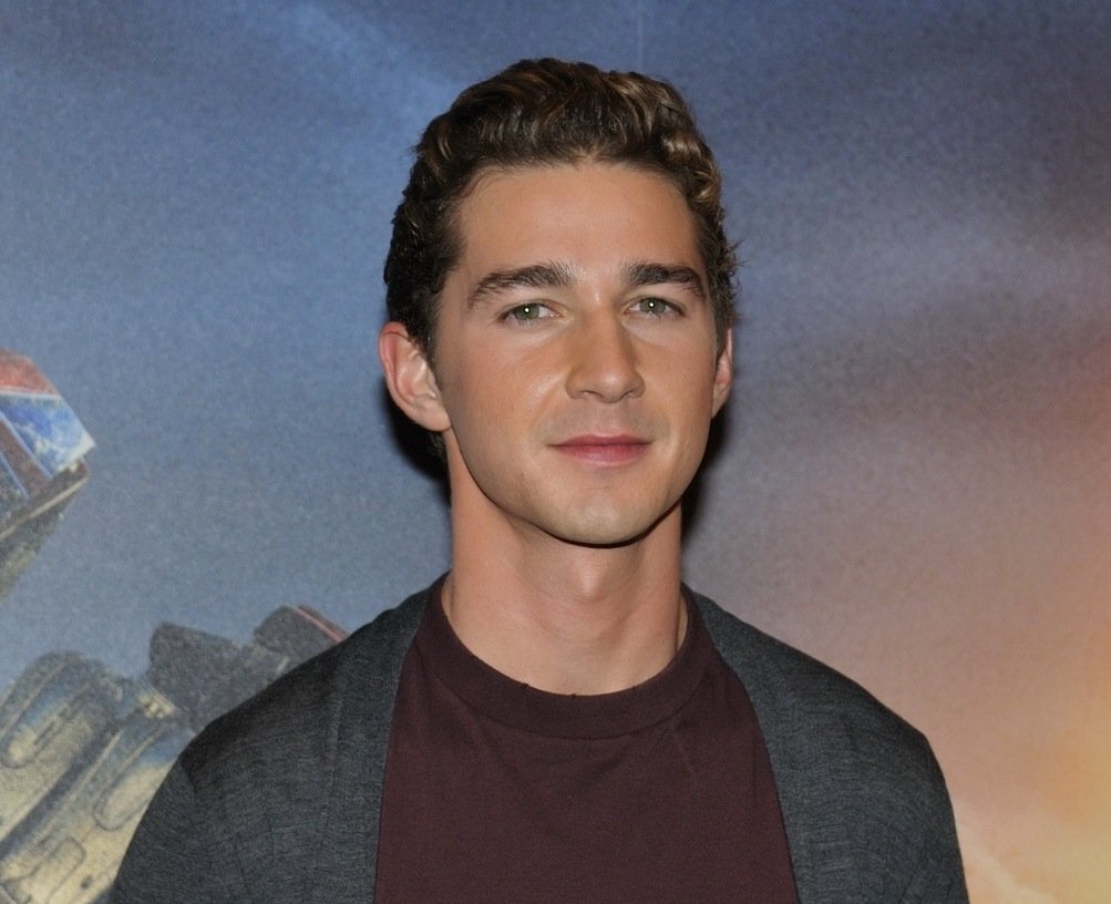 Portrait Photo of the Actor Shia LaBeouf in a gray and red outfit