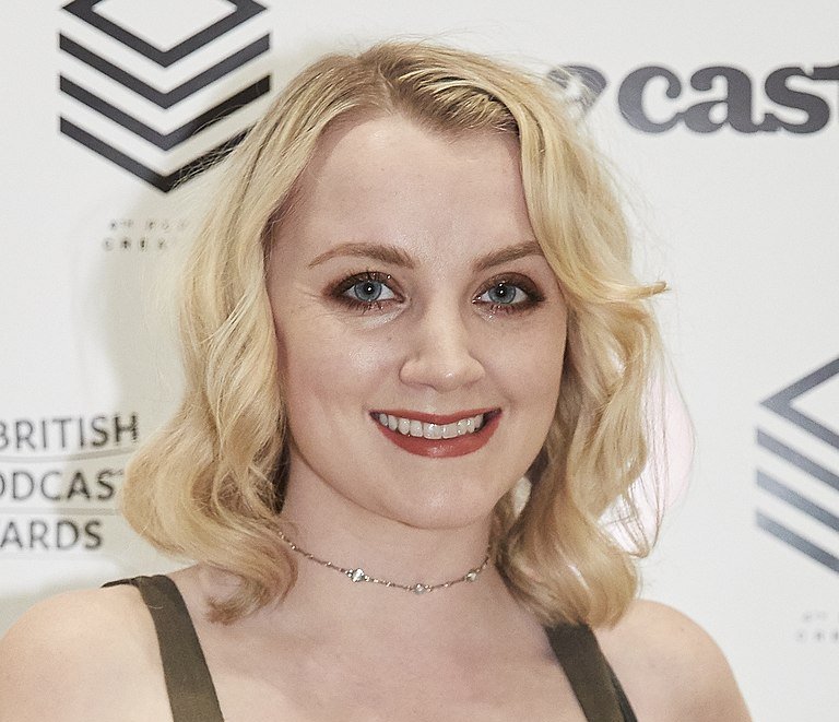 Portrait Photo of Evanna Lynch in a brown outfit