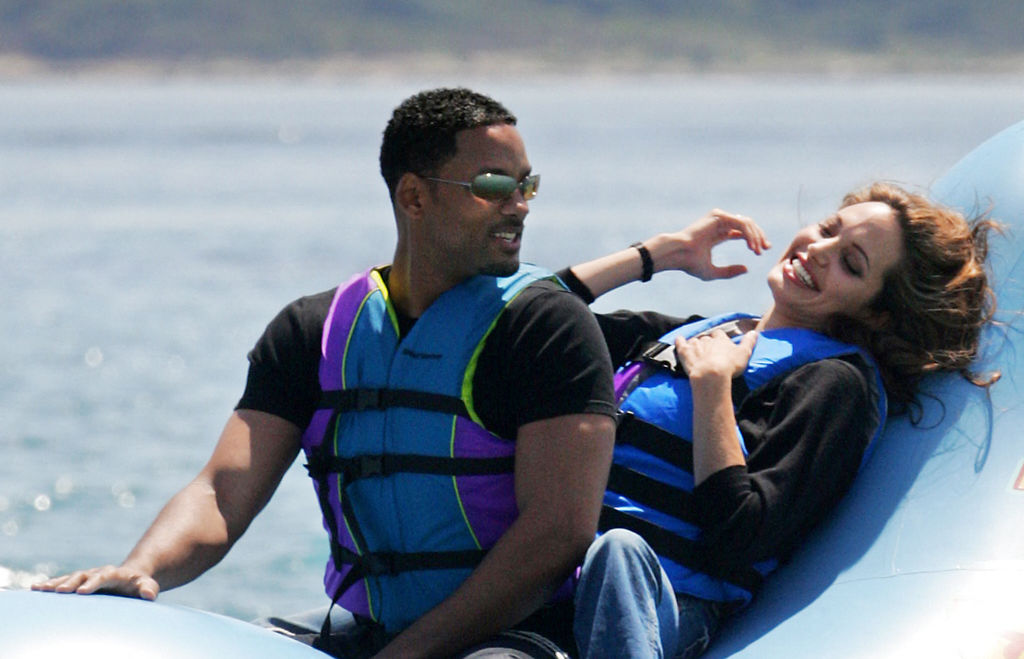 Will Smith riding a float in water