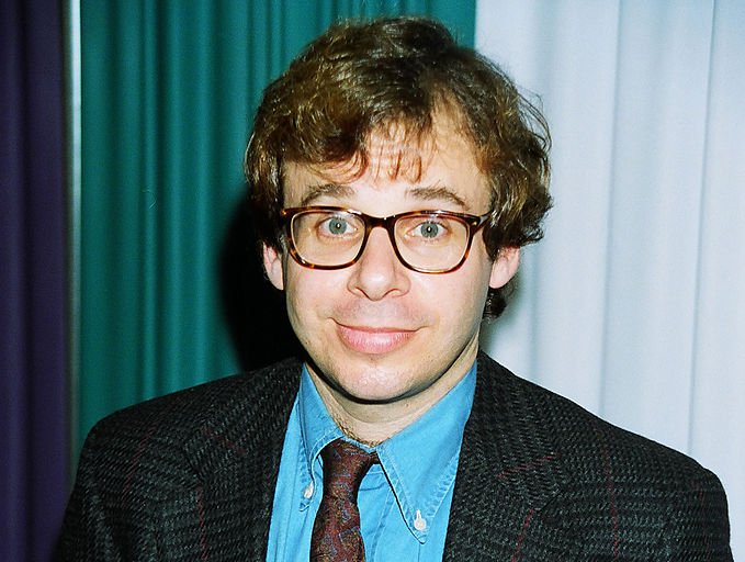 Portrait Photo of the actor Rick Moranis in a dark suit