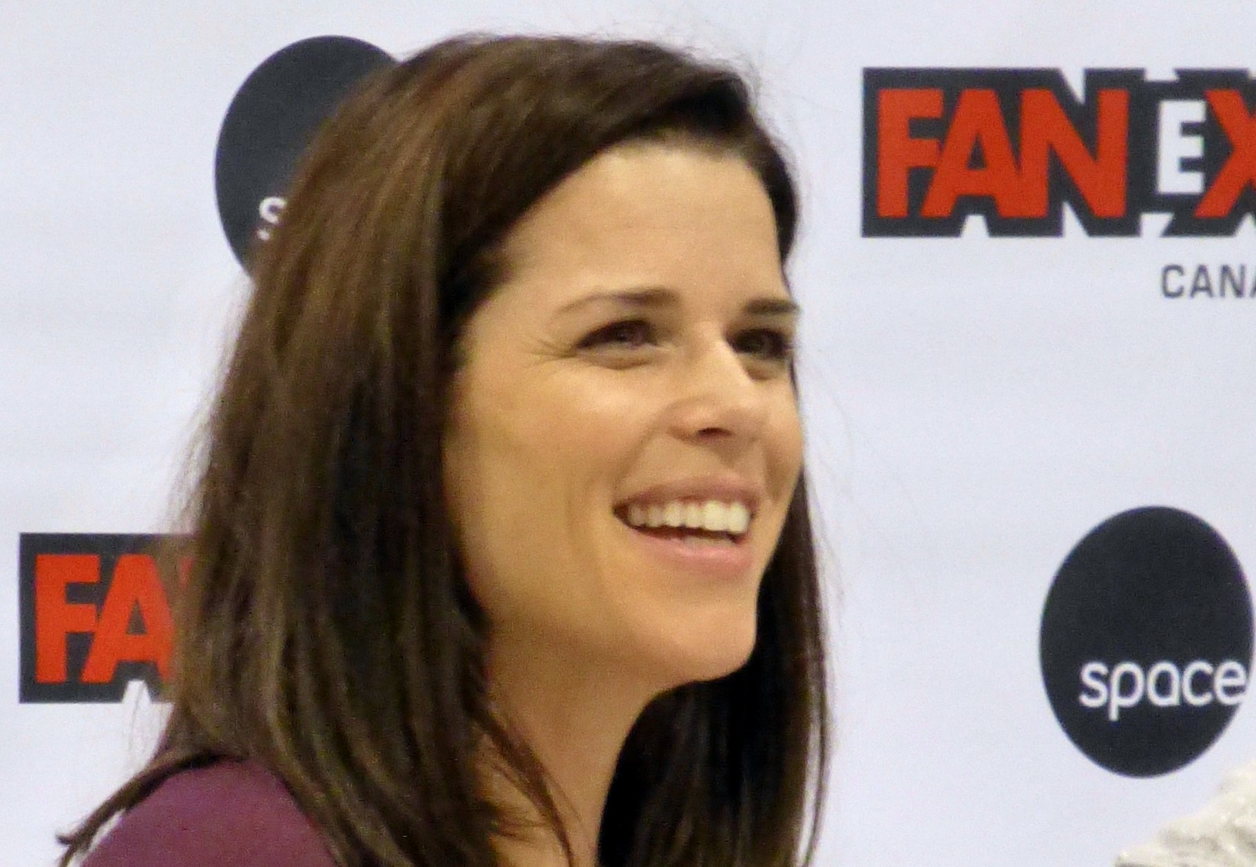 Portrait Photo of the Actress Neve Campbell in a purple dress