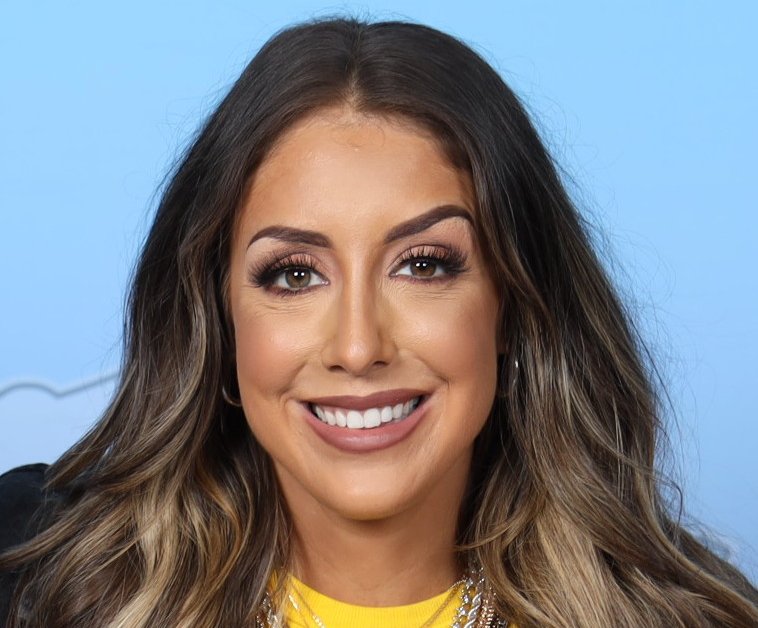 Portrait Photo of Britt Baker in yellow outfit, smiling