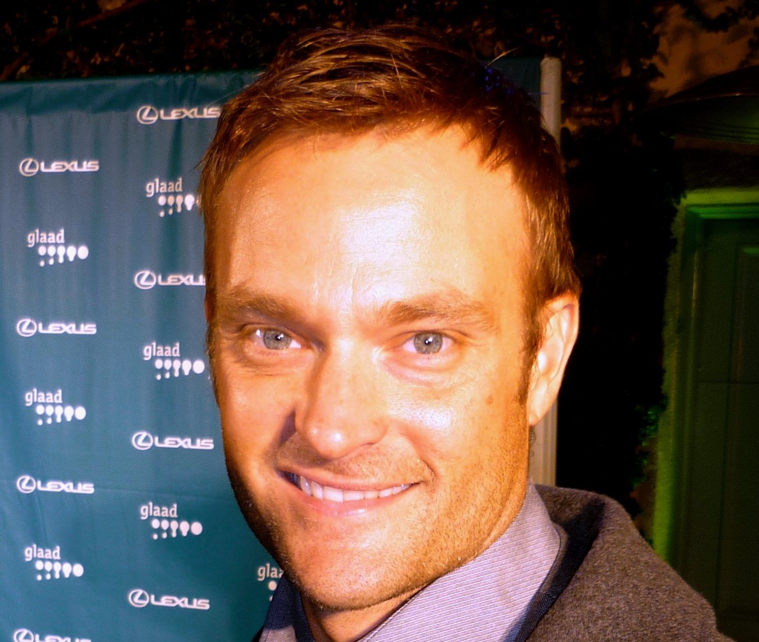 Portrait Photo of Actor Chad Allen in a brown suit, smiling