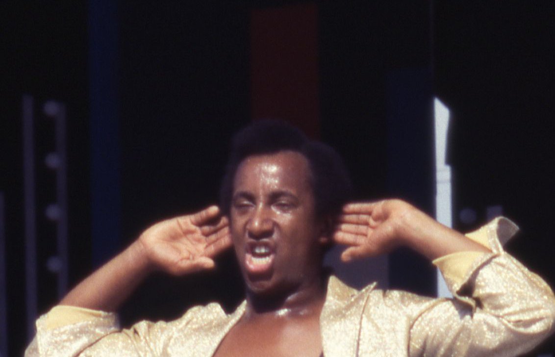 A view of Denny Greene, dressed in gold lame, of the band Sha Na Na