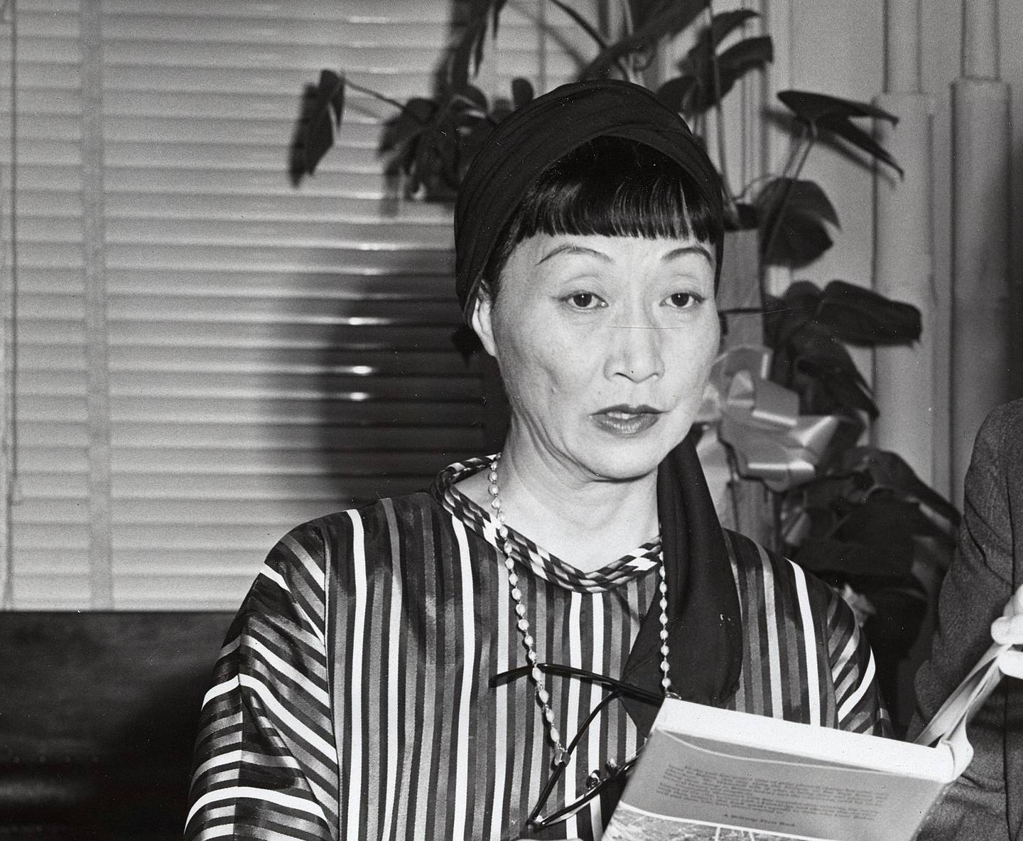 Actress Anna May Wong in a striped dress