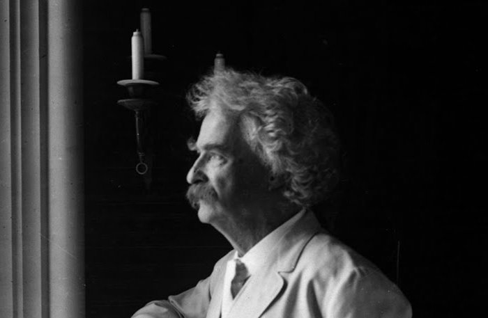 Grayscale Portrait Photo of Mark Twain in a white suit