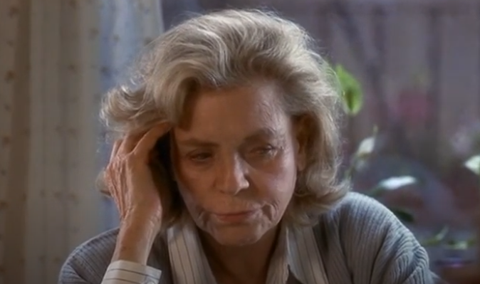 Lauren Bacall in the Mirror has two faces wearing a blue sweater