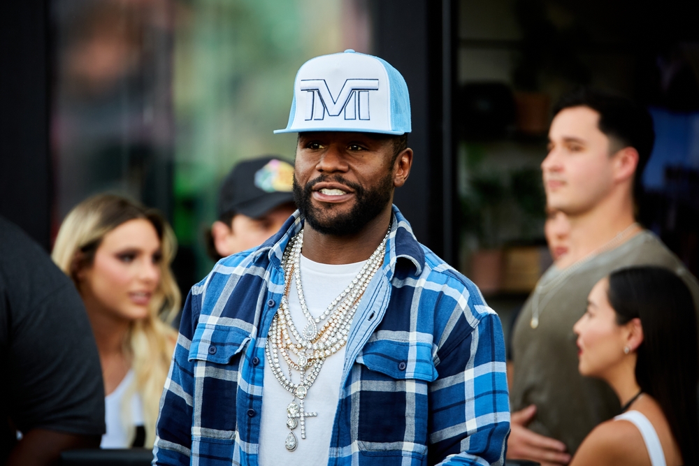 Portrait Photo of Floyd Mayweather in a blue shirt and baseball hat