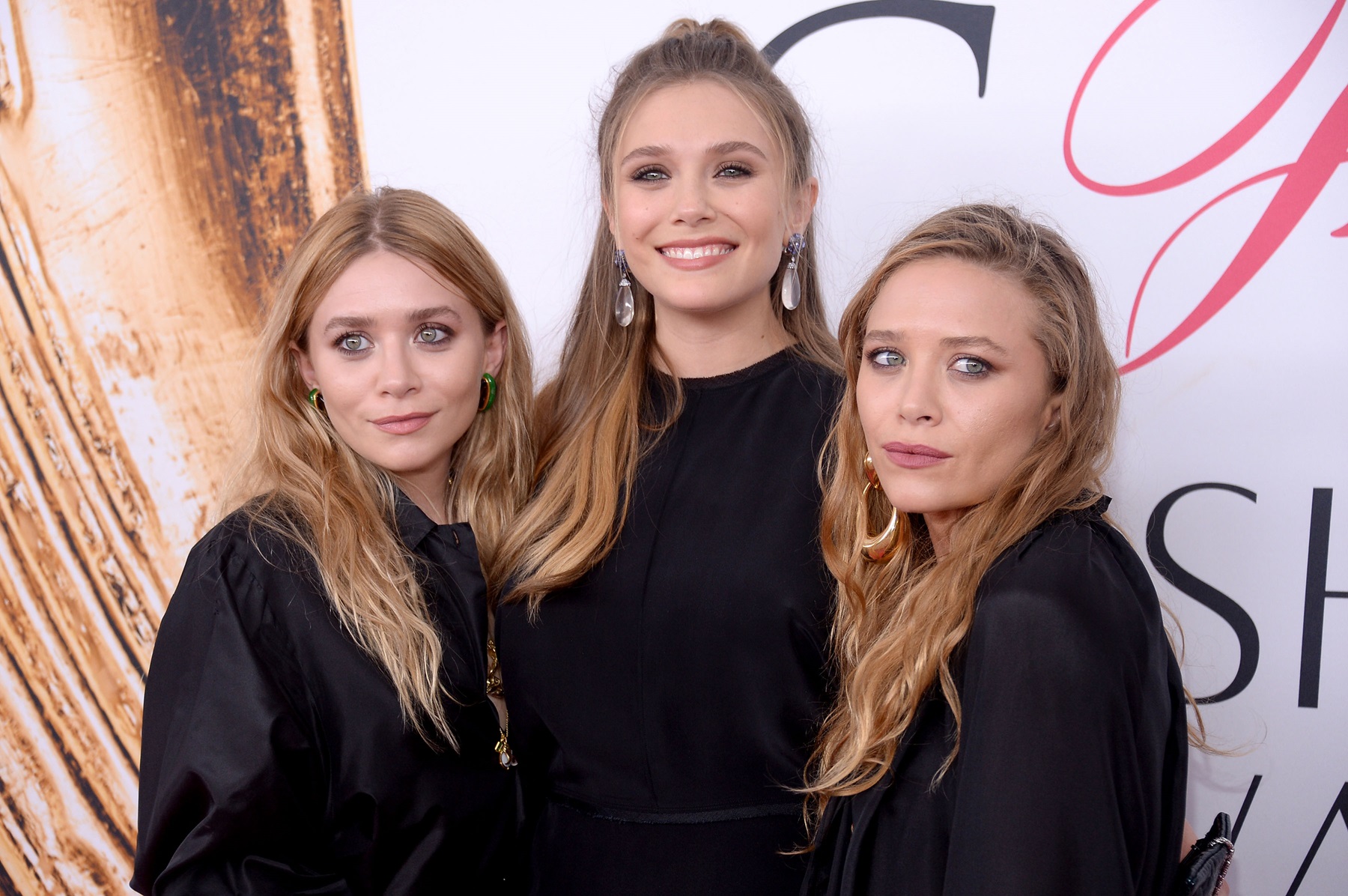 Elizabeth Olsen (center) and Mary-Kate and Ashley Olsen attend the 2016 CFDA Fashion Awards