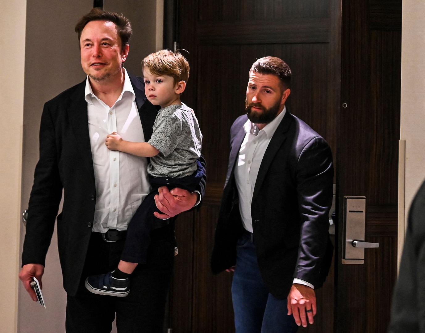 Elon Musk holds one of his children - 2023