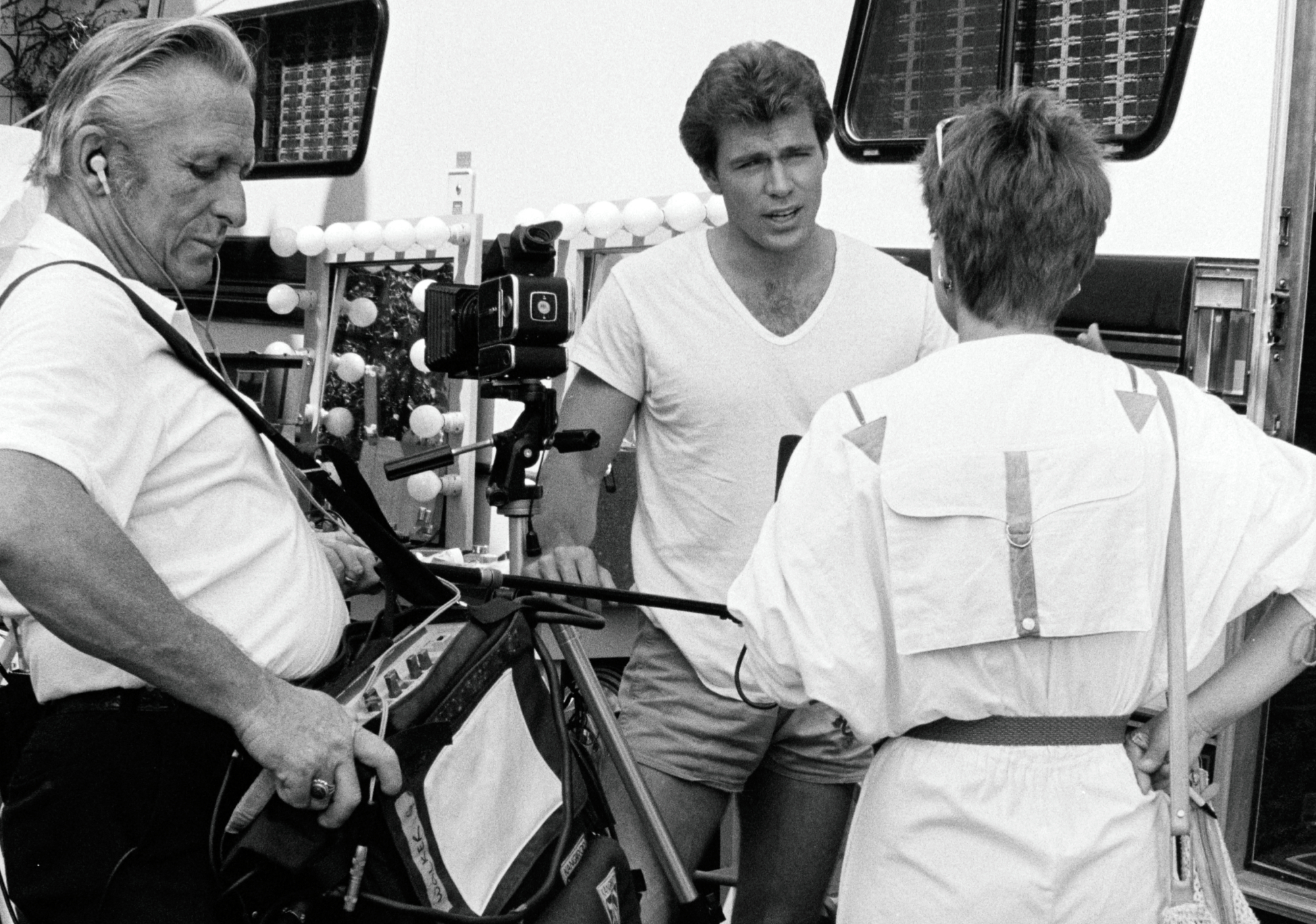 Jon-Erik Hexum (C) and crew members prepare for filming