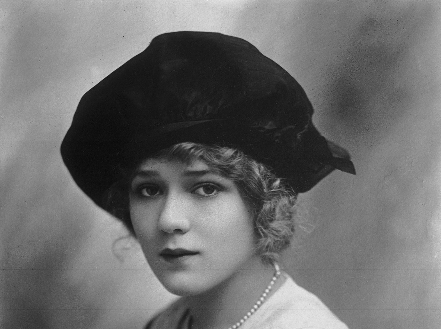 Grayscale Portrait Photo of Mary Pickford in white dress and black hat