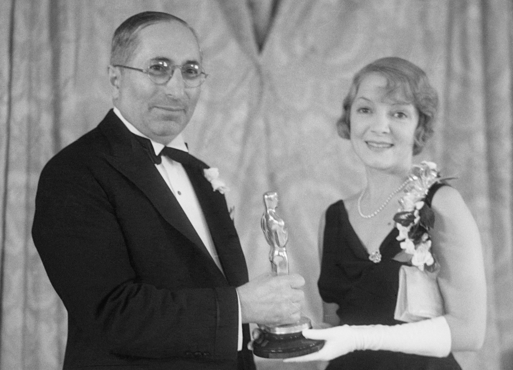Actress Helen Hayes and producer Louis Mayer hold onto the Oscar award which was presented to Hayes on November 19, 1932.