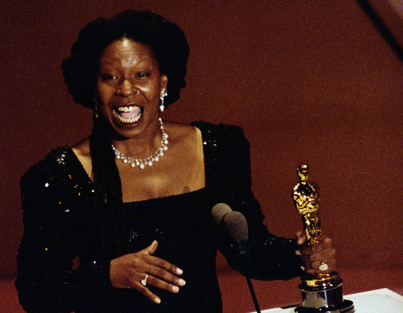 Whoopi Goldberg holds her Best Supporting Actress Oscar - 1991