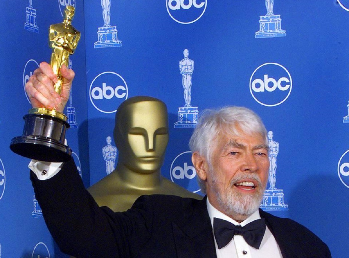 US veteran actor James Coburn holding up his Oscar - 1999
