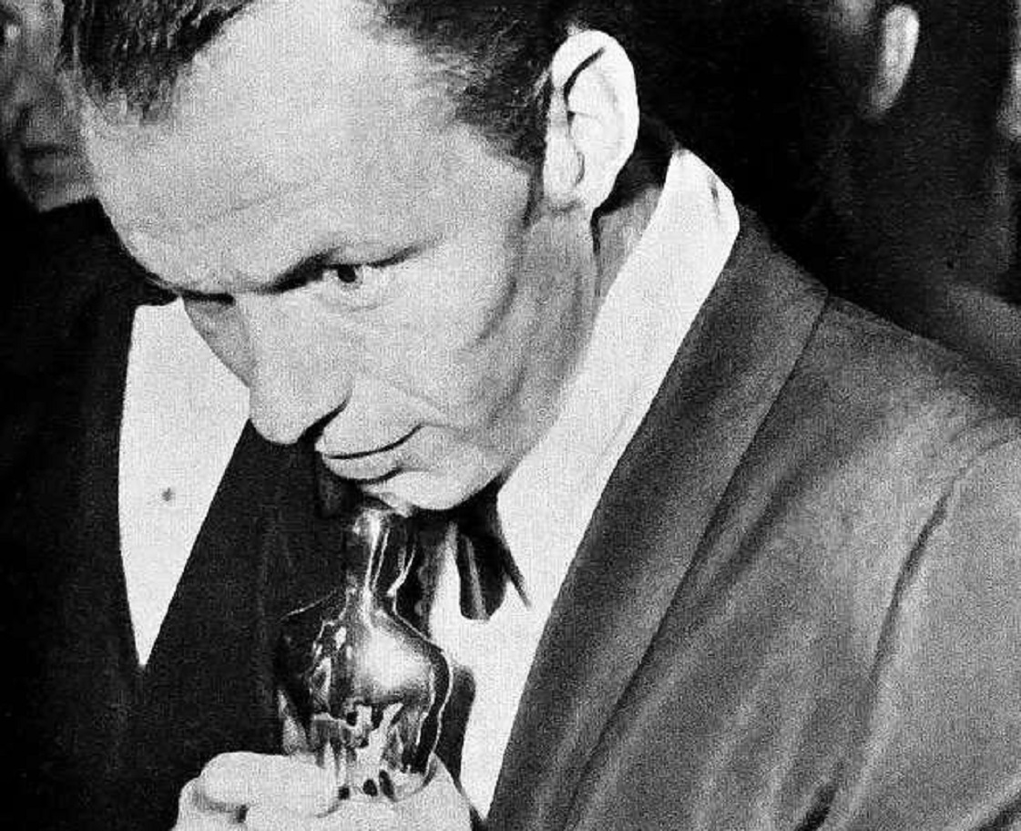 Photograph of Frank Sinatra holding his Oscar statuette - 1954