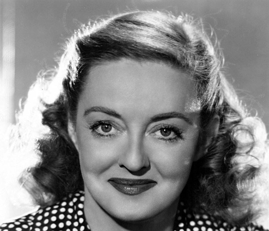 Grayscale Portrait Photo of Bette Davis, smiling, facing the camera