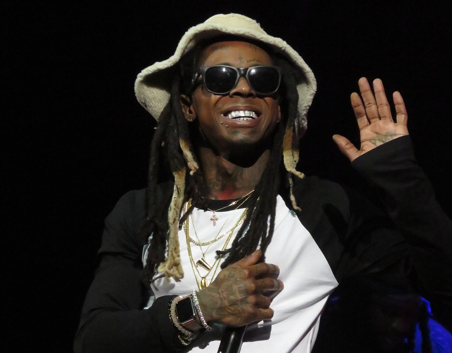Lil Wayne in white shirt and hat performing on Stage